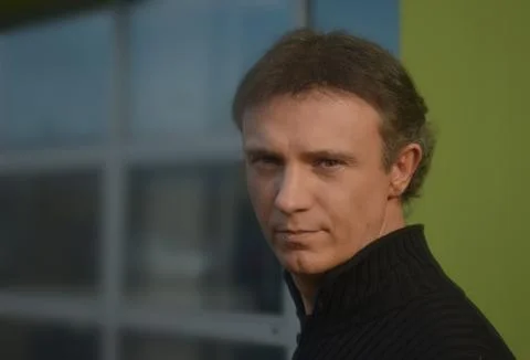 Handsome man in front of office windows Stock Photos