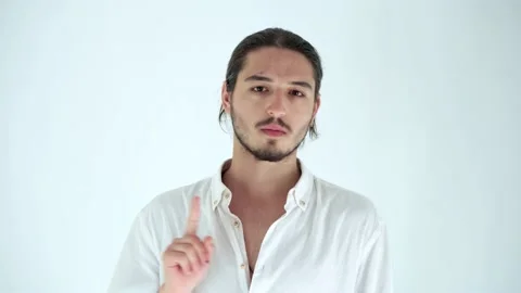 Handsome man gesturing a no sign and shaking his head. Don't do, be careful 動画素材 136007112