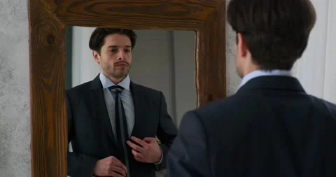 Handsome man getting ready in front of a mirror Видео 239241788