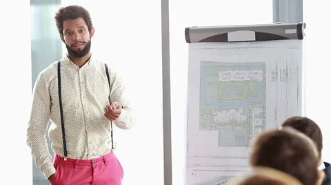 Handsome man giving presentation to his colleagues Stock Footage 59542176