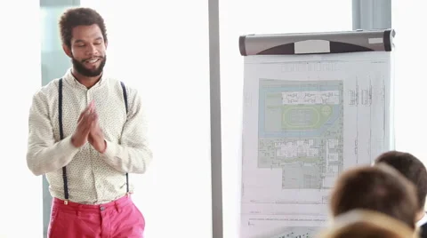 Handsome man giving presentation to his colleagues Stock Footage 59542187