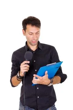 Handsome man giving speech on microphone reading notes Stock Photos