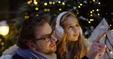Handsome man in glasses hugging with his pretty daughter, talking and looking Stock Footage 83187455