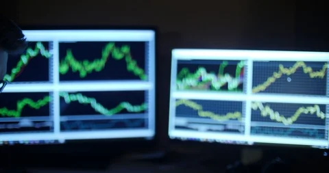 Handsome man in glasses uses tablet against the background of graphs Stock Footage 88060735