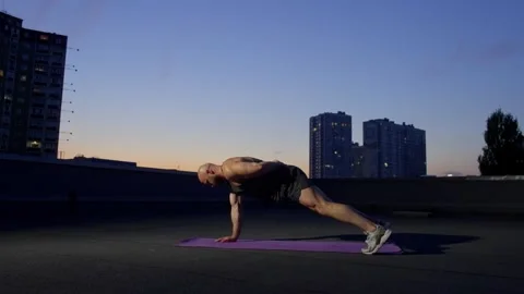 Handsome man in great shape doing sports in night city. Stock Footage 260299404
