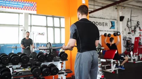 Handsome man at the gym doing exercises Stock Footage 62445557