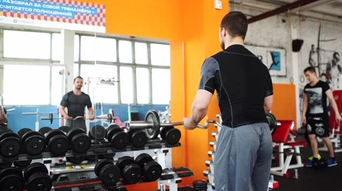 Handsome man at the gym doing exercises Stock Footage 62445588