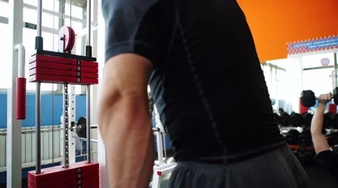 Handsome man at the gym doing exercises Stock Footage 62445726
