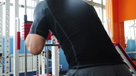 Handsome man at the gym doing exercises Stock Footage 62445753