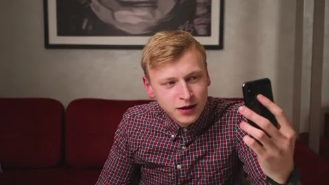 Handsome man has video call chatting on phone in slow motion. Close up smiling Stock Footage 146613640