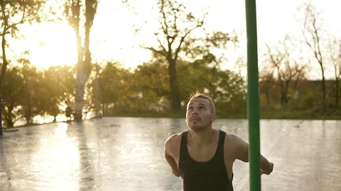 Handsome man having calisthenics training on horizontal bar outdoors. Does 스톡 동영상 99311082