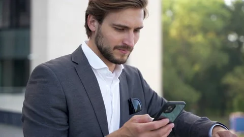 Handsome man having phone talk outdoor. Businessman talking on smartphone Stock Footage 211779078