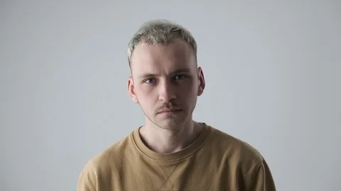 Handsome man with head cocked Stock Footage 105189453
