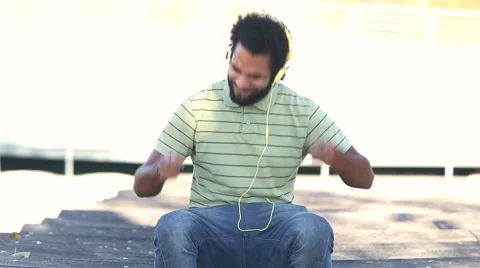 Handsome man with headphones listening to music Stock Footage 59555483