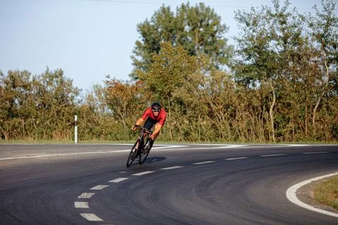 Handsome man in helmet having active training on bike Stock Photos