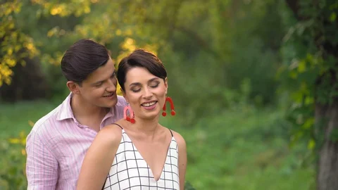 Handsome Man Hugging His Beloved Woman In The Summer Park Stock Footage 130065737