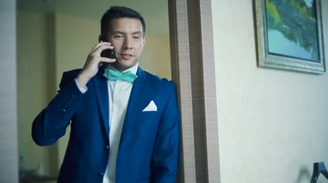 Handsome man in jacket talking on the phone Stock Footage 62828881