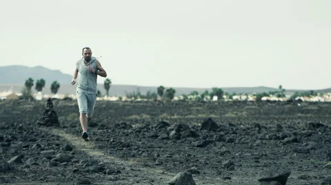 Handsome man jogging on desert, slow motion shot at 240fps HD Stock Footage 46147306