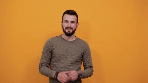 Handsome man keeping hands on cheeks, beard, smiling, looking happy Video stock 121440142
