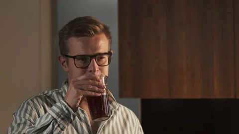 Handsome man on kitchen is smiling and drinking coffee at home, good morning Stock Footage 140198626