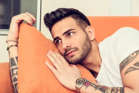 Handsome man laying on couch Stock Photos