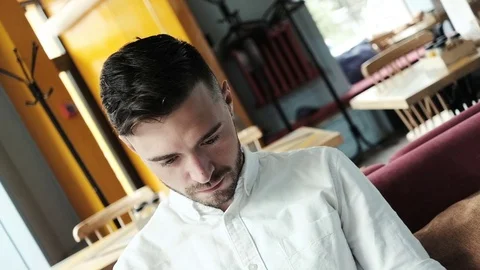 Handsome man looking at camera and smiling. Shot with motion. Close up shot. Stock Footage 77000478