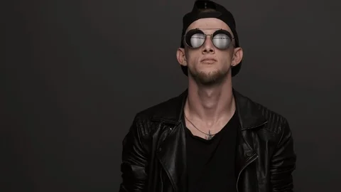 Handsome man looking at camera and smiling. Stylish man takes off glasses Stock Footage 116376495