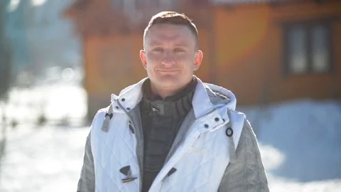 Handsome Man is Looking At The Camera being Outside During Sunny Winter Day. Clo Stock Footage 72793198