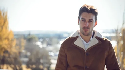 Handsome man looking at camera in sunlight Stock Footage 86470262