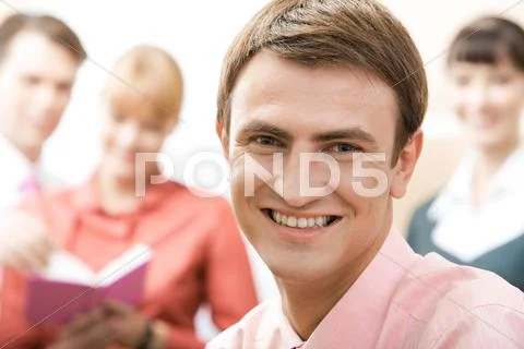 Handsome man looking at camera in working environment Stock Photos