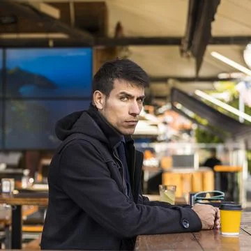 Handsome man looking seriously at camera after drinking a coffee Stock Photos