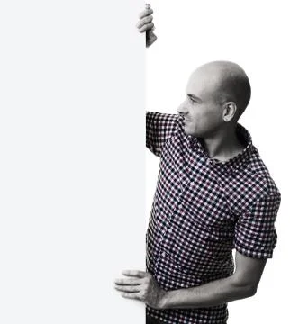 Handsome man looking at a white panel isolated Stock Photos