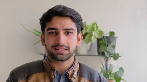 Handsome man looks at the camera and smiles wide showing his teeth  Stock Footage 101286196