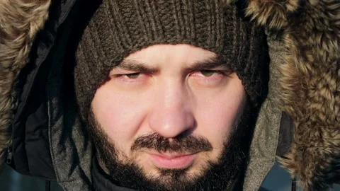 Handsome man looks into the camera. Young man is angry and looks at the camera Stock Footage 225063780