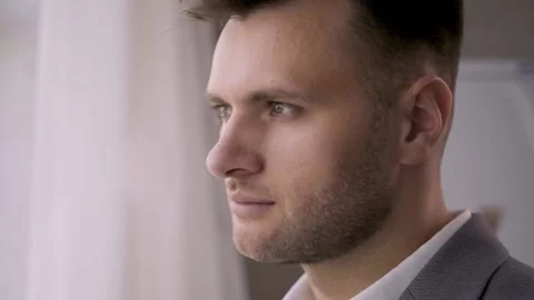 A handsome man looks directly at the camera and turns away. Fashion Stock Footage 141562889