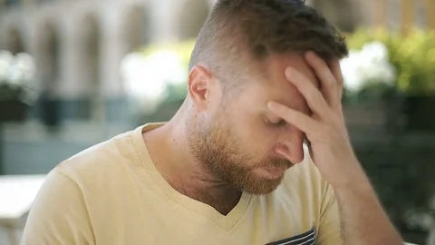Handsome man looks worried while sitting in the cafe, steadycam shot 스톡 동영상 76986201