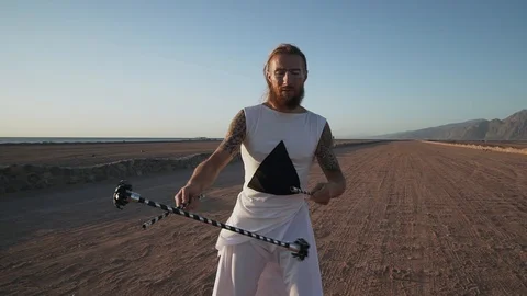 Handsome man make flaverstik performance at sunset shaky footage slow motion Stock Footage 99499080