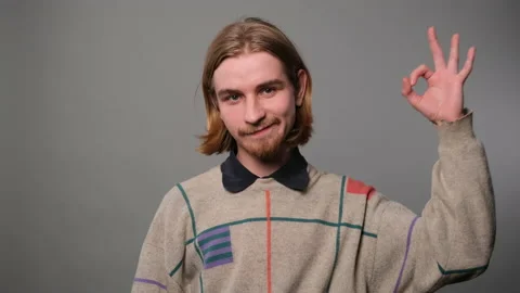 Handsome man makes hand sign okay Stockbeeldmateriaal 229136108