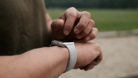 Handsome man making gestures on a wearable smartwatch computer device Stock Footage 113062660