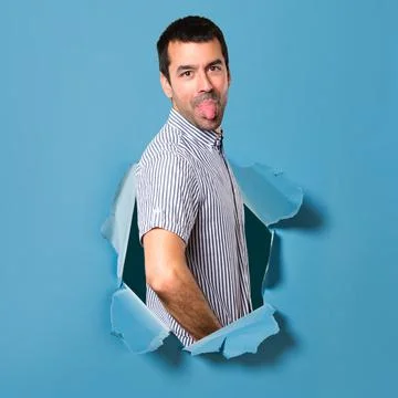 Handsome man making a joke through a paper hole Stock Photos