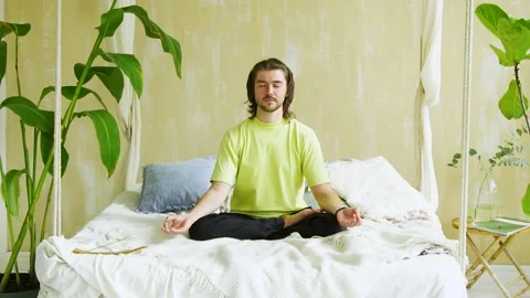 Handsome man making namaste position after meditation at home Stock Footage 141455376