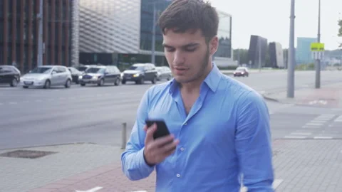 Handsome man making a phone call near a busy street Stock-Footage 133098748