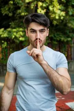 Handsome man making a shushing gesture Foto stock