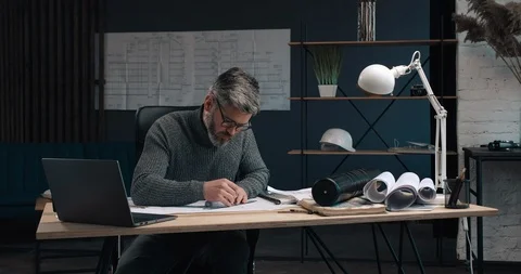 Handsome Man of Middle age working like an Architect at his Modern Office Stock Footage 126245432