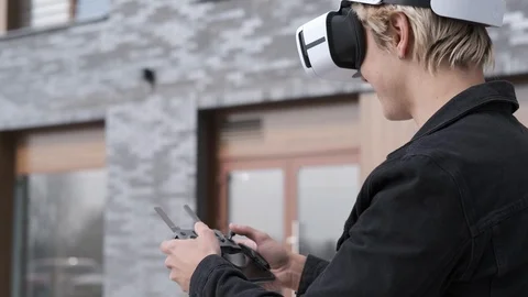 Handsome man in modern virtual reality glasses controlling flying copter Video stock 106261098