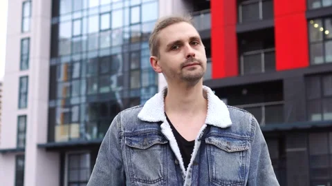 Handsome man nodding head as saying no and looking at camera outdoors. Stock Footage 145484179