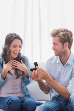 Handsome man offering an engagement ring Stock Photos