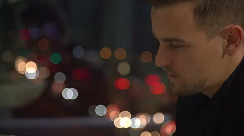 Handsome man over night city background is waiting for somebody Stock Footage 60056622