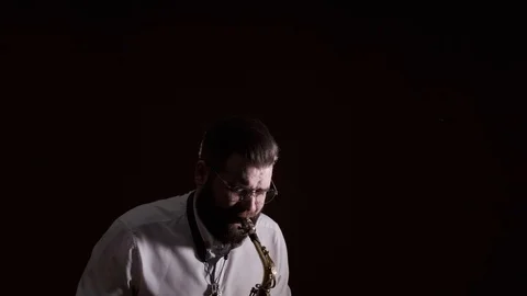 Handsome man playing the saxophone, black background, isolated, solo Stock-Footage 127054503