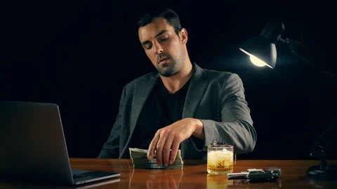 Handsome man plays with a stack of cash Stockbeeldmateriaal 102528481